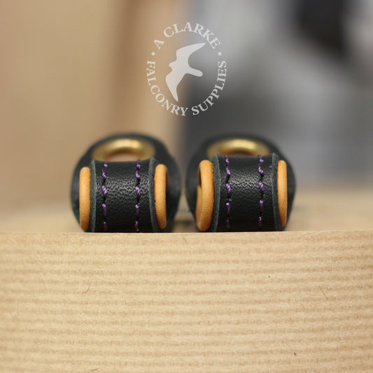 A pair of bespoke lined anklets with tan lining and purple stitching!
