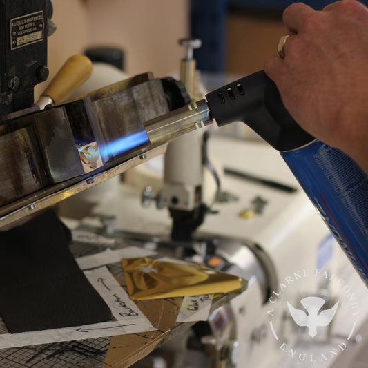 Ashley firing up the heat ready to hot stamp our logo onto a Barkston glove...