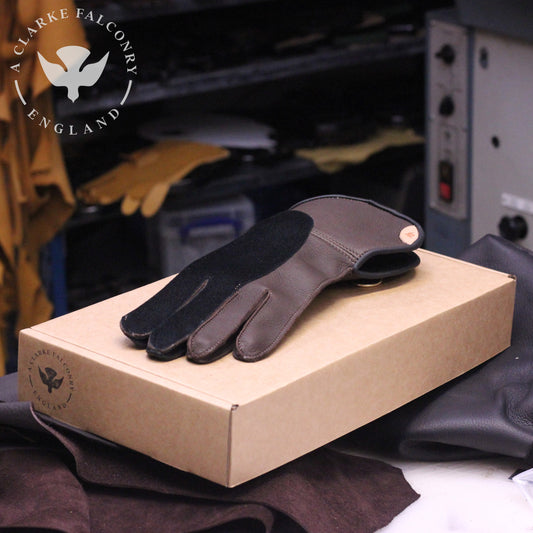 A bespoke double thickness glove in brown with black overlay and matching binding!